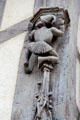Carving detail of man in Medieval dress climbing pillar on Acrobats house. Blois, France