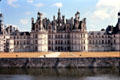 Front facade of Chambord Chateau seen across moat. Chambord, France.