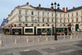 Tram rounds corner at Place St Croix. France.