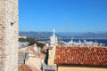 View of rooftops, ships & harbor. Antibes, France.