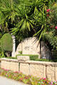 Palms & carved antique stone in garden at Villa Ephrussi de Rothschild. Saint Jean Cap Ferrat, France.