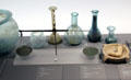 Collection of Roman glass bottles & bronze balance at Musée de la Romanité. Nimes, France.