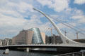 Dublin Convention Center framed by Samuel Beckett Bridge over River Liffey. Dublin, Ireland