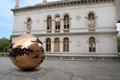 Sphere Within Sphere sculpture by Arnaldo Pomodoro & Museum Building at Trinity College. Dublin, Ireland.