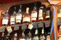 Premium Irish whiskey bottles lining shelves at Dick Mack's Pub in Dingle. Dingle, Ireland.