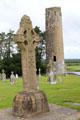 O'Rourke's Round tower with replica of South Cross at Clonmacnoise. Ireland.