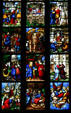 Scenes of stained-glass saints in Duomo. Milan, Italy.
