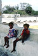 Children sit on wall of San Antonio de Padua at Izamal. Mexico.