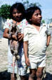 Children holding a pet armadillo in a Yucatan village. Mexico.