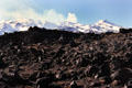Lava field in front of snow covered volcano Mount Ruapehu. New Zealand.