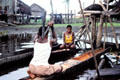 Flailing flour in a floating canoe at Kamburamba. Papua New Guinea.