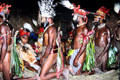 Men on knees approach women during a courtship ritual near Banz. Papua New Guinea