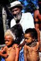Chief of the Mudmen village with his two grandsons, one who is blond. Papua New Guinea.
