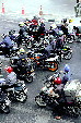 Motorcyclists await the light to change on Rama I Road in Bangkok. Thailand.