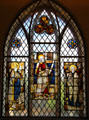 Stained glass window with three saints at St Mungo's Museum. Glasgow, Scotland.