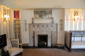 Drawing room fireplace area with inset shelves at Hill House. Helensburgh, Scotland