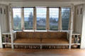 Window seat with many signature designs of C.R. Mackintosh in drawing room at Hill House. Helensburgh, Scotland.