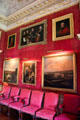 Art work on red damask wall in Red Drawing Room at Hopetoun House. Queensferry, Scotland.