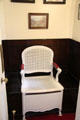 Commode chair in bathroom with flush pull on floor at Lauriston Castle. Edinburgh, Scotland