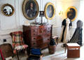 Dressing room with portraits & Scottish chest of drawers with square drawer for hats at Traquair House. Scotland.
