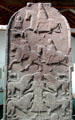 Pictish cross-slab with strips showing mounted huntsmen with dogs, mounted warriors, the Vanora execution by lions scene at Meigle Sculptured Stone Museum. Meigle, Scotland.