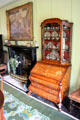 Inlaid desk with china cabinet beside dining room fireplace at Broughton House. Kirkcudbright, Scotland.