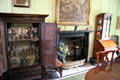 Cabinet with collection of pewter beside dining room fireplace at Broughton House. Kirkcudbright, Scotland.
