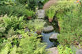 Pond with stepping stones in garden at Broughton House. Kirkcudbright, Scotland.