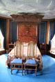 Half canopy bed with Forbes crest on headboard in Blue room at Craigievar Castle. Alford, Scotland.