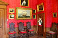 Collection of paintings in red drawing room at Brodie Castle. Brodie, Scotland.