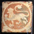 Medieval inlaid clay heraldic lion floor tile from Keynsham Abbey, Somerset at Gladstone Pottery Museum. Longton, Stoke, England.