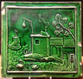 Earthenware molded tile with green glaze probably Thomas Whieldon pot works of Fenton, Straffordshire at Potteries Museum & Art Gallery. Hanley, Stoke-on-Trent, England.