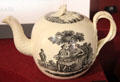 Creamware teapot with transfer printing of couple having tea in garden attrib. Wedgwood of Burslem or Etruria, Staffordshire at Potteries Museum & Art Gallery. Hanley, Stoke-on-Trent, England.