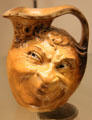 Ceramic jug modeled with leering face by R,W. Martin & Bros. of London & Southall at Potteries Museum & Art Gallery. Hanley, Stoke-on-Trent, England.