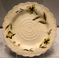 Queen's Ware plate with molded Tudor rose & painted yellow & black enamel flower prob. James Bakewell for Wedgwood at World of Wedgwood. Barlaston, Stoke, England.