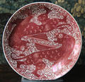 Red lustre plate with lions by Charles Passenger for William De Morgan at Wightwick Manor. Wolverhampton, England.