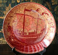 Ruby lustre plate with galleon in full sail by William De Morgan at Wightwick Manor. Wolverhampton, England.