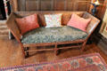 Oak settee in Cromwellian style with seat covered by Morris-style fabric & pillows by Charles Eamer Kempe in Great Parlor at Wightwick Manor. Wolverhampton, England.