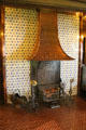 Billiard room fireplace with some metal parts possibly by Morris & Co surrounded by Dutch tiles at Wightwick Manor. Wolverhampton, England.