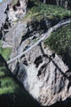 Carrick-a-rede Rope Bridge casts shadow on cliffs below. Northern Ireland.