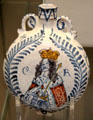 Earthenware tin-glazed wine flask with painted bust of King Charles II at British Museum. London, United Kingdom.