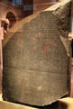 Rosetta Stone is inscribed with three versions of a decree: Ancient Egyptian in hieroglyphics & Demotic scripts plus Ancient Greek which was used to decode the top two writings. at British Museum. London, United Kingdom.