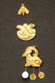 Three Minoan sheet gold ornaments showing bee, lions, goat from Crete at British Museum. London, United Kingdom.