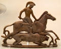 Terracotta plaque shows Bellerophon riding Pegasus raising sword against Chimera lion with goat emerging from back made on Melos at British Museum. London, United Kingdom.
