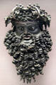 Bronze mask of horned Dionysus once handle for wine bucket at British Museum. London, United Kingdom.