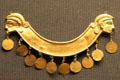 Minoan gold breast ornament with human profiles & pendant discs made in Crete at British Museum. London, United Kingdom.