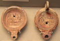 Roman oil lamps showing victorious chariot teams made in Italy at British Museum. London, United Kingdom.