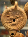 Terracotta oil lamp with Attis on a cult-car pulled by rams made in Italy, found in Surrey? at British Museum. London, United Kingdom.