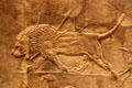 Assyrian carved panel shows dying lion from North Palace of Nineveh at British Museum. London, United Kingdom.