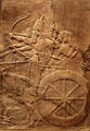Assyrian carved panel shows lion hunt by chariot from North Palace of Nineveh at British Museum. London, United Kingdom.